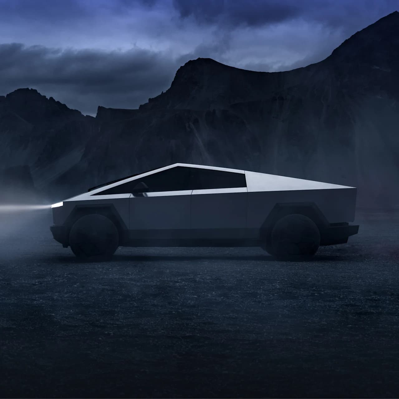 Silver Tesla Cybertruck in a dramatic mountain landscape